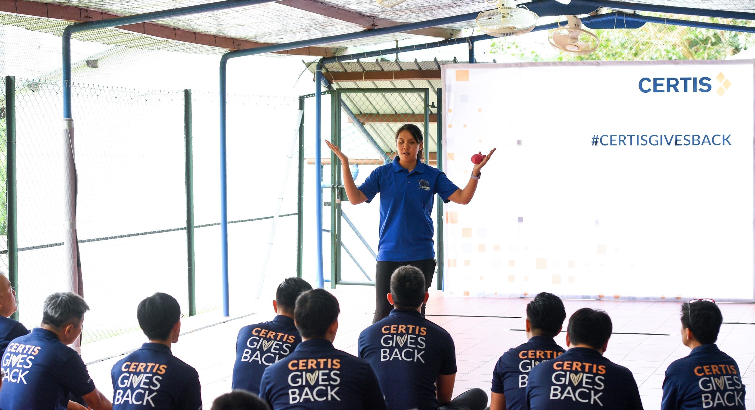 Joan_Hung_explaning_the_game_of_Goalball_to_Certis_volunteers_and_Lighthouse_School_Students